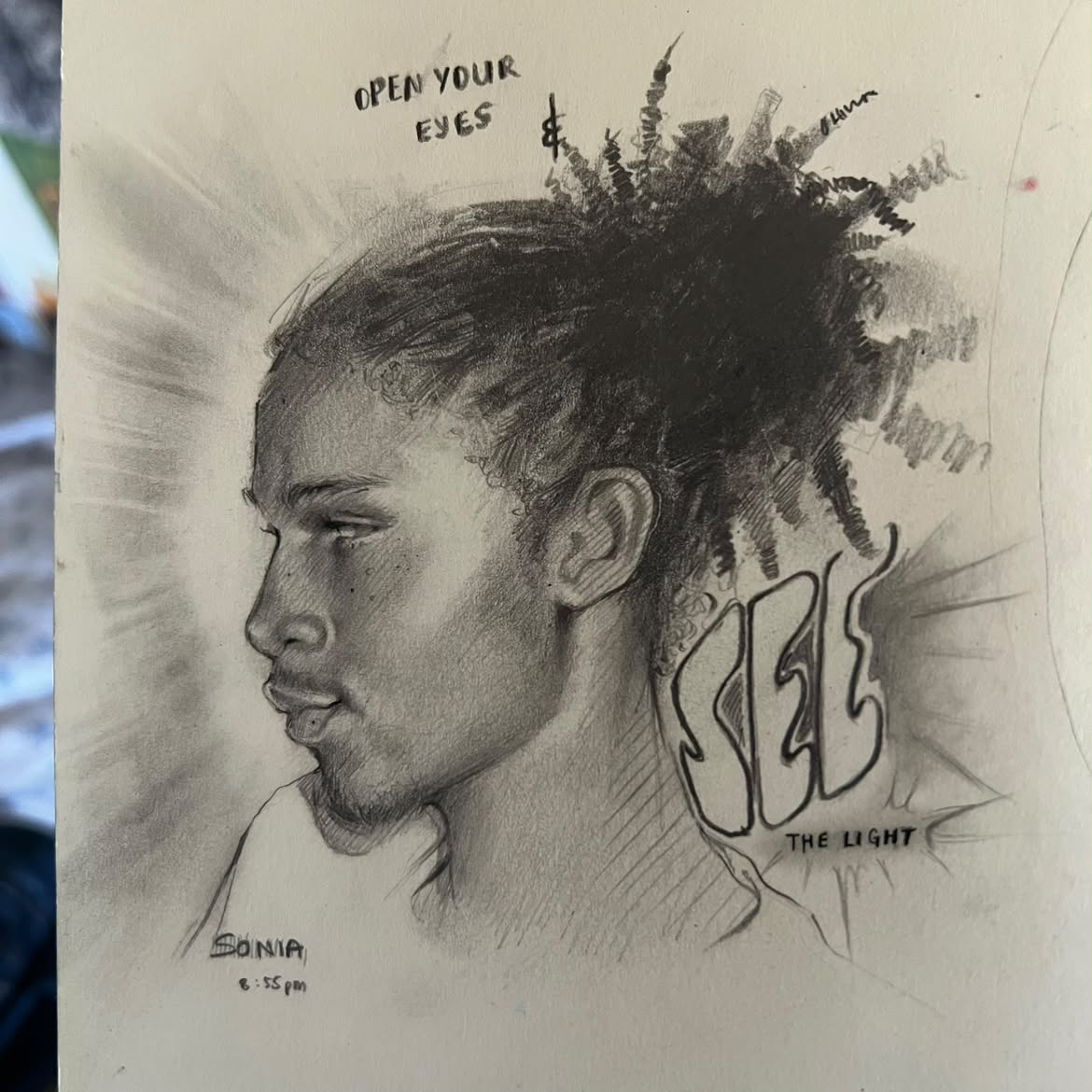 Graphite portrait drawing with the words Open Your Eyes