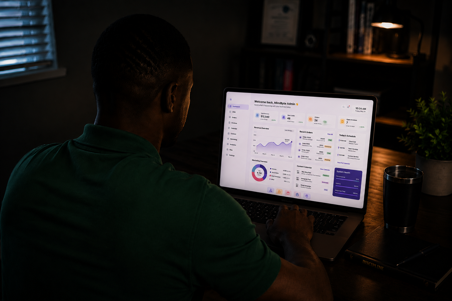 Person working on a laptop showing a MimiByte admin dashboard